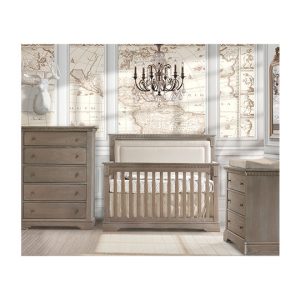 Baby room with world map wallpaper, wooden crib with beige upholstered panel, 3 drawer dresser and 5 drawer dresser
