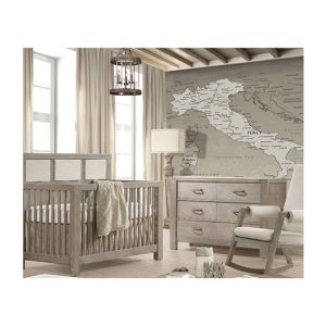 Rustic baby nursery with a map of italy wallpaper and grey wooden double dresser and crib with beige upholstered panel and a rocking chair with beige cushions