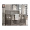 Rustic Baby nursery with wood panelled wall, and a dark wood convertible crib