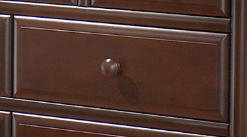 Close up of dark brown wood dresser drawer