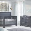 Nursery with charcoal colored crib and double dresser with a grey changing mat