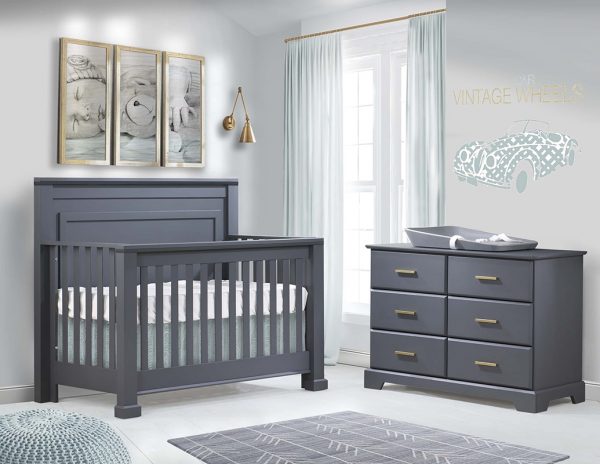 Nursery with charcoal colored crib and double dresser with a grey changing mat