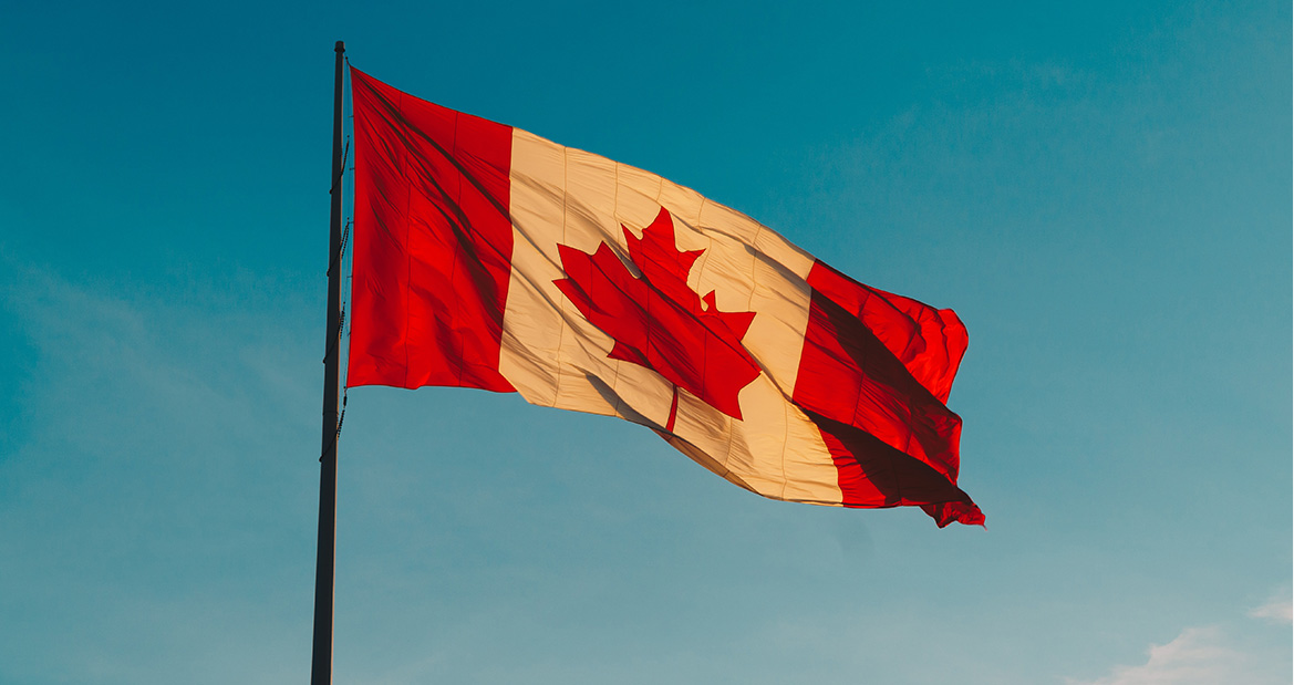 canada flag and blue skies