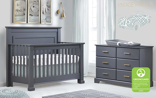 Nursery with charcoal colored crib and double dresser with a grey changing mat