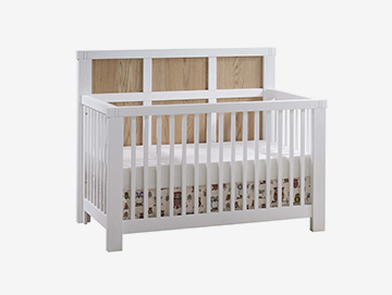 White and natural colored wood panels crib