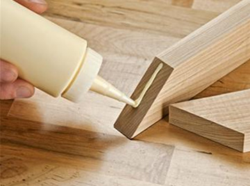 Applying glue on wood planks