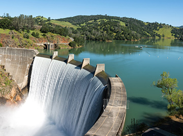 Water damn and green forest