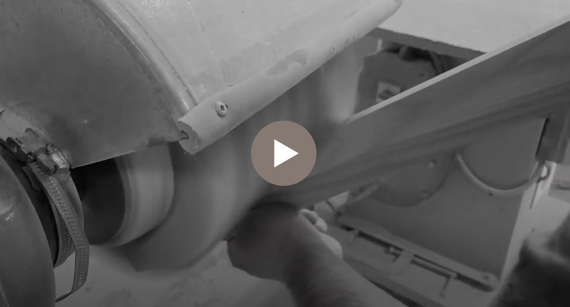 warehouse worker sanding a piece of wood