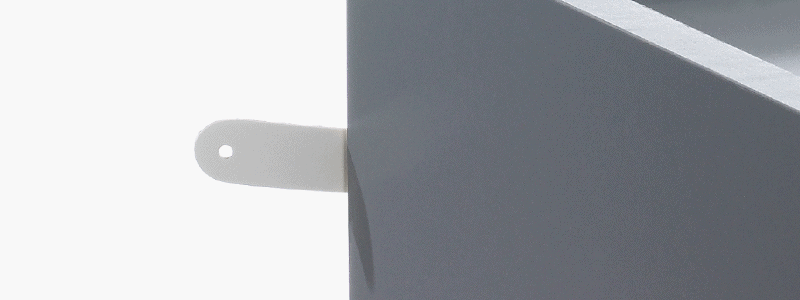 Close up of safety strap attached to grey nursery dresser